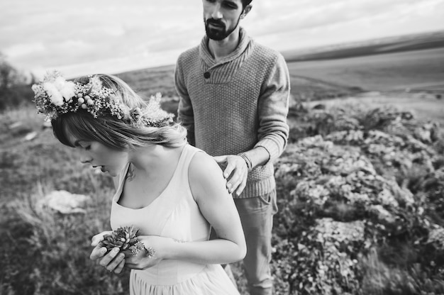 couple in the field near the mountains