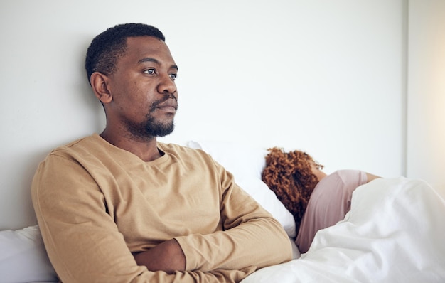 Couple fight angry black man and bedroom with a woman together feeling frustrated in a bed Home conflict and relationship problem of a marriage fail divorce issue and break up stress in morning