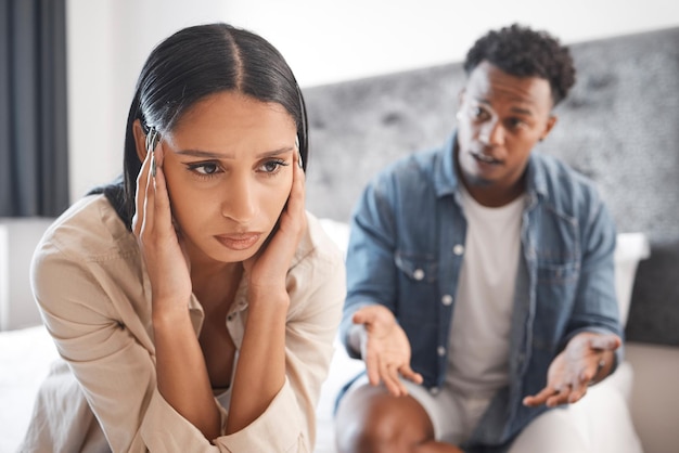 Couple fight marriage depression and divorce stress anxiety from mental health and tired of conflict in house bedroom Sad woman frustrated with headache during communication with man about problem