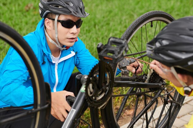 Couple Fixing Bicycle Wheel