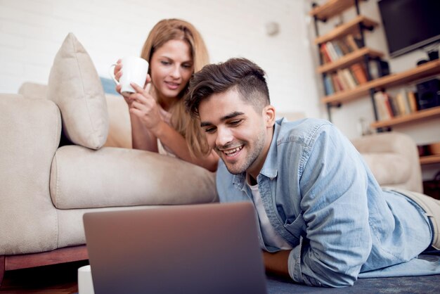 Couple on floor with laptop