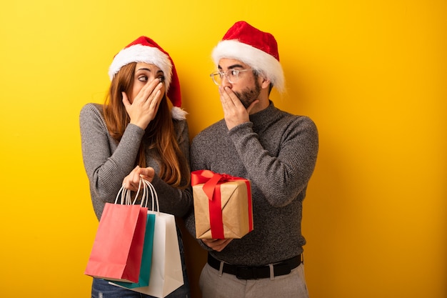 Couple or friends holding gifts and shopping bags very scared and afraid hidden