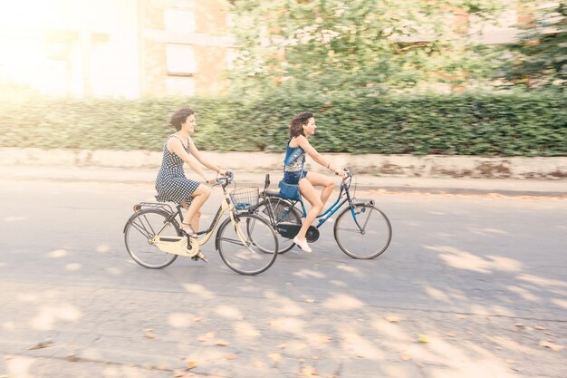 A couple of friends with bikes, motion blur