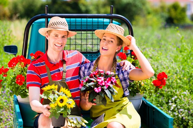 Couple in garden with flowers on gape