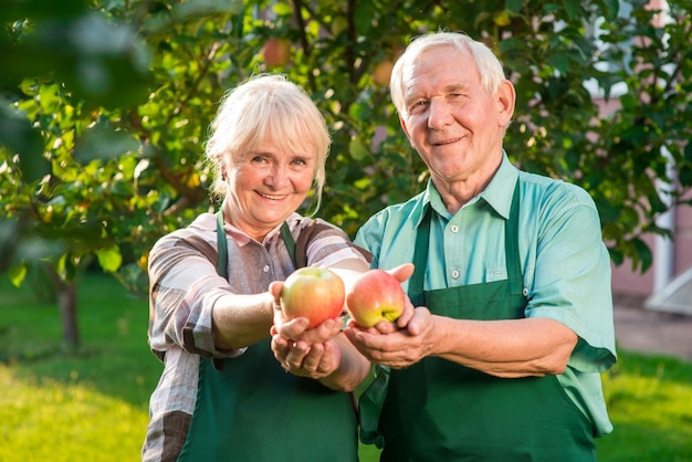 Couple of gardeners holding apples