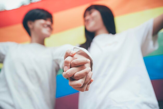 Photo couple of girl with girllgbt pride month conceptasian handsome male make up and wear woman clothgay freedom dayportrait of nonbinary on white background
