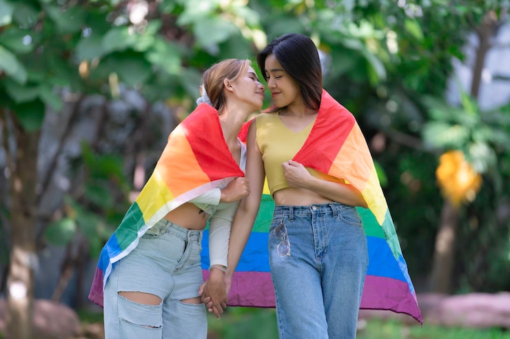Photo couple of girl with girllgbt pride month conceptasian handsome male make up and wear woman clothgay freedom dayportrait of nonbinary on white background