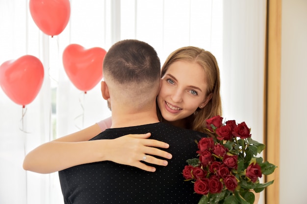 Couple giving rose flower in bedroom happiness in valentine's day selective focus