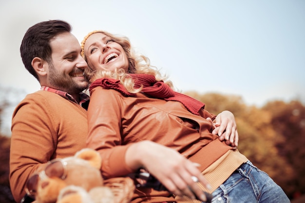 Couple going for a ride with the bicycle in the park