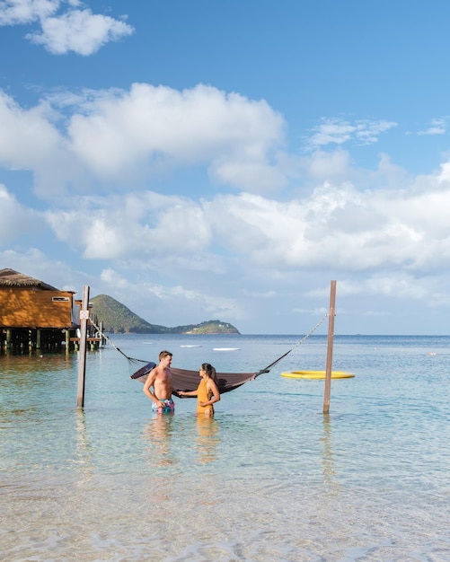 Couple in hammock on the beach of the tropical island saint\
lucia or st lucia caribbean