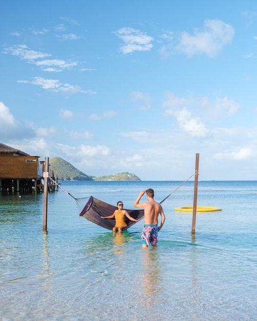 Couple in hammock on the beach of the tropical island saint\
lucia or st lucia caribbean