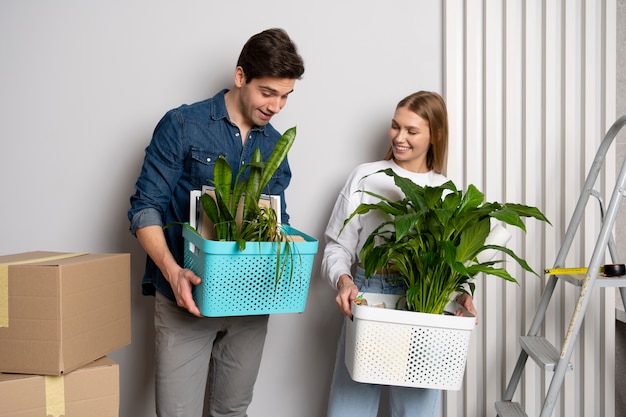 Photo couple handling boxes of belongings after moving in a new house