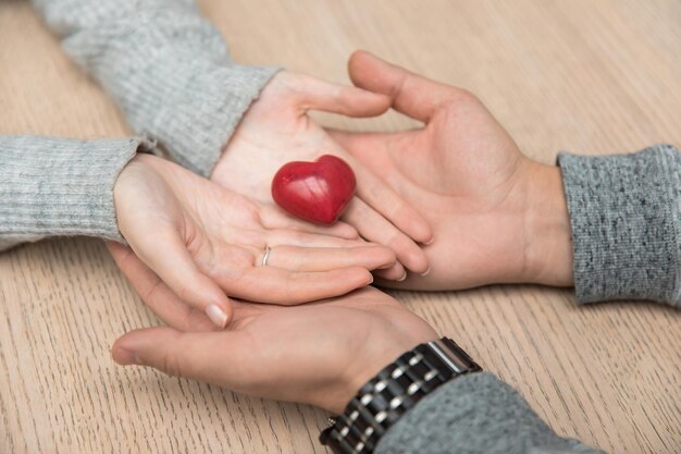 Couple hands red heart