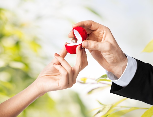 couple hands with wedding ring and gift box