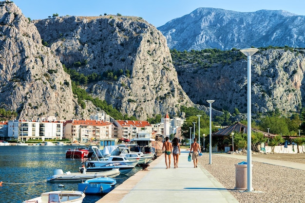 Couple at the harbor in the Cetina River in Omis, Croatia