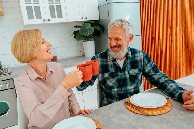 Couple has breakfast at home with coffee and fruits