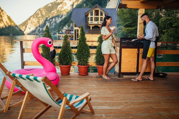 Couple having a barbecue at the lake