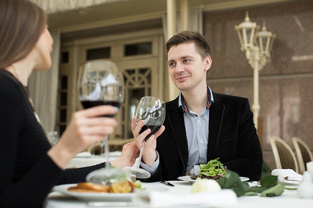 Couple having dinner at a restaurant and making a toast