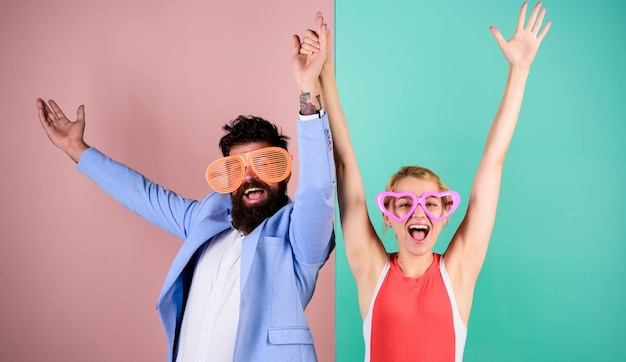 Couple having fun Office party Playful businessman and colleague celebrating Celebrating holiday Bearded man pretty woman party goggles celebrating Corporate culture Diving into celebration