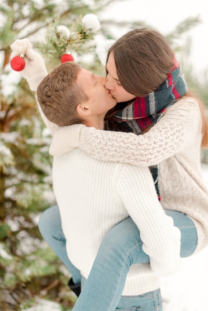 Couple having fun in snowy forest