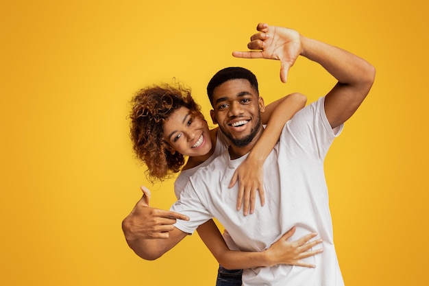 Photo couple having fun taking picture with imaginary camera