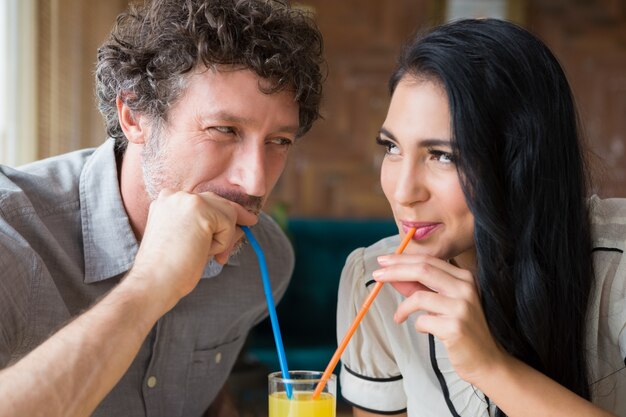 Couple having juice in cafeteria