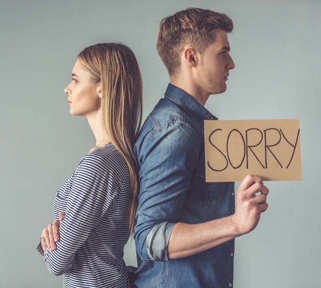 Couple having a quarrel, standing back to back.