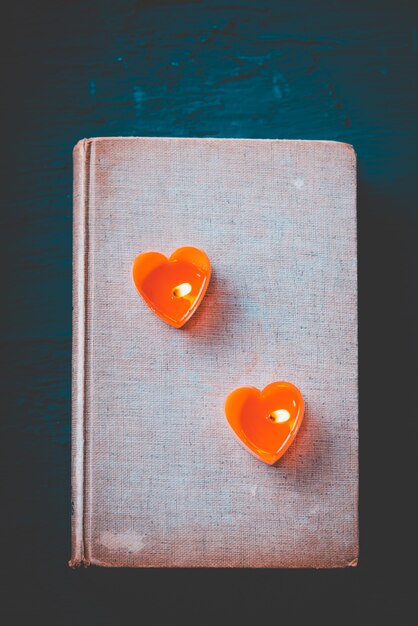 Couple heart is candles on old book, Vintage dark filter