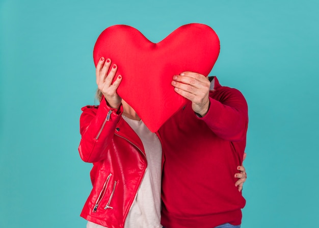 Couple holding big red heart