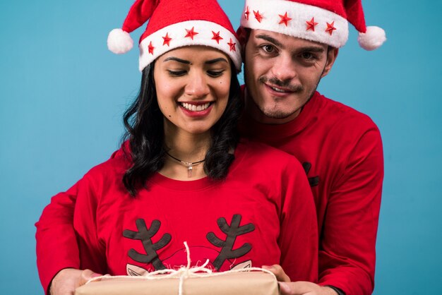 Couple holding Christmas present