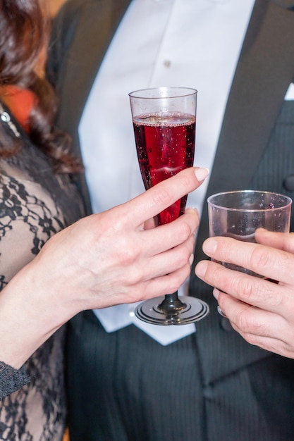 A couple holding a glass of red wine