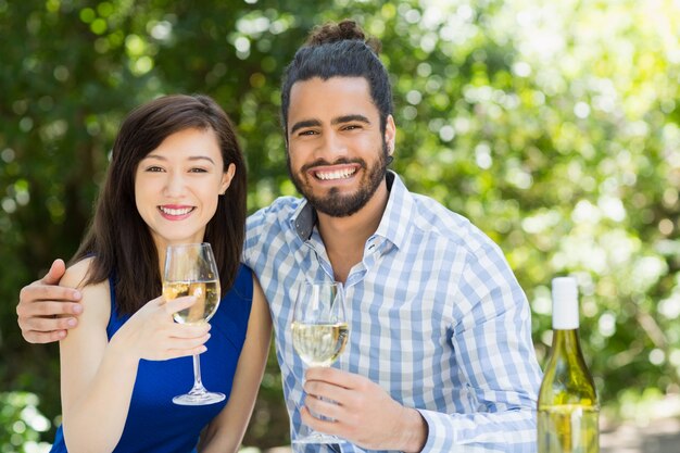 Couple holding glasses of wine in a restaurant