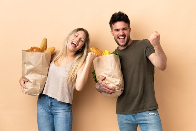 Couple holding grocery shopping bags