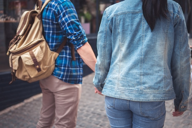 Couple holding hand travel in town and walking street