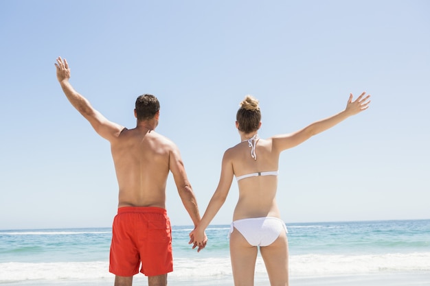 Couple holding hands at the beach