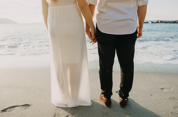 A couple holding hands on the beach