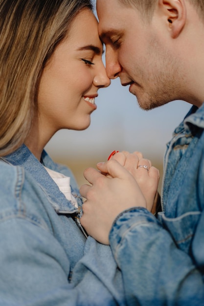 Couple holding hands and kissing in a park