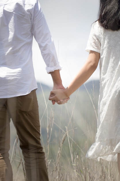 Couple holding hands in nature