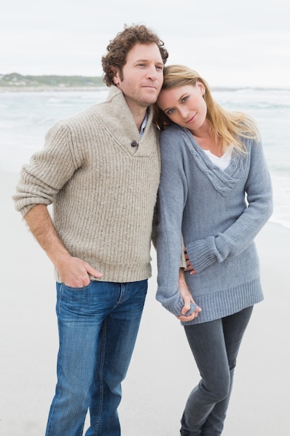 Couple holding hands and standing at beach