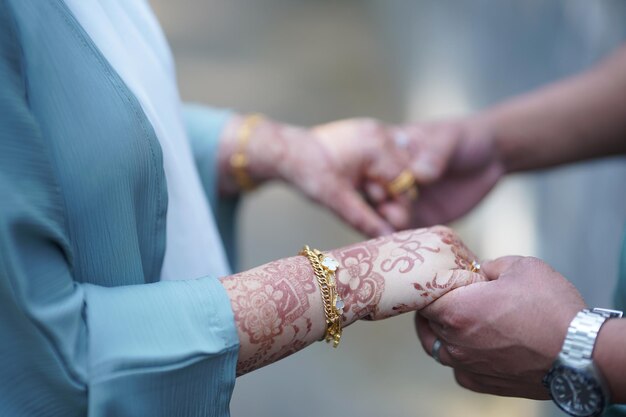 Couple holding hands with gold bracelet