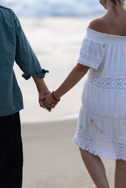 A couple holding hands, the word love on the bottom right.