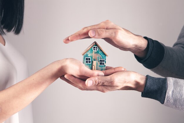 Couple holding house toy