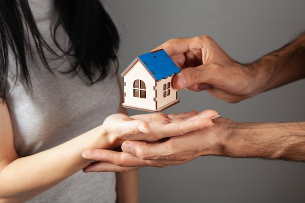 A couple holding a house