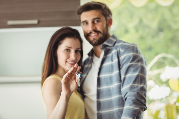 Couple holding keys in their new house