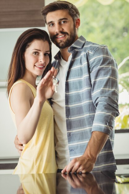 Couple holding keys in their new house