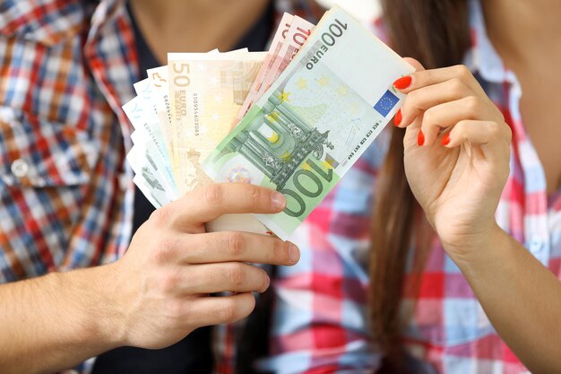 Couple holding money banknotes closeup