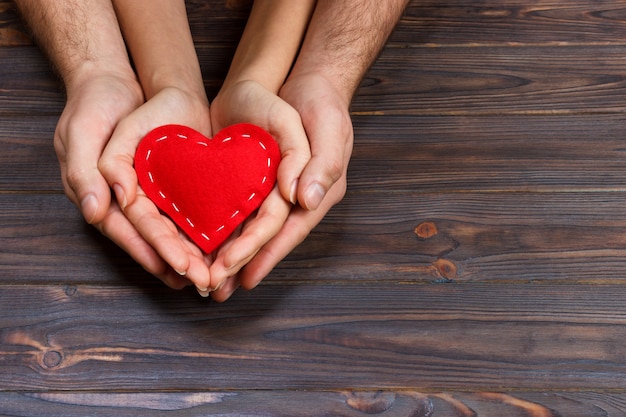 Couple holding red heart