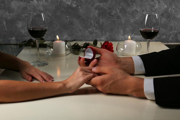 Couple holding their hands in restaurant