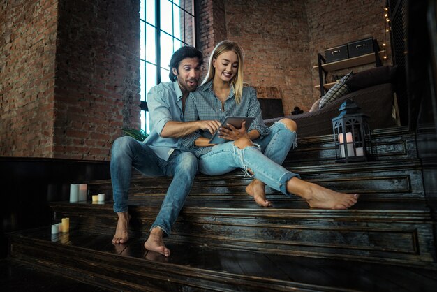 Couple at home watching tablet