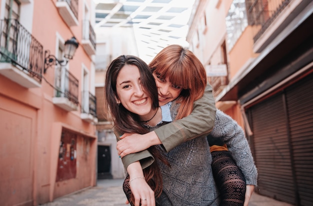 Couple of homosexual girls while he takes her in his arms and\
they are happy